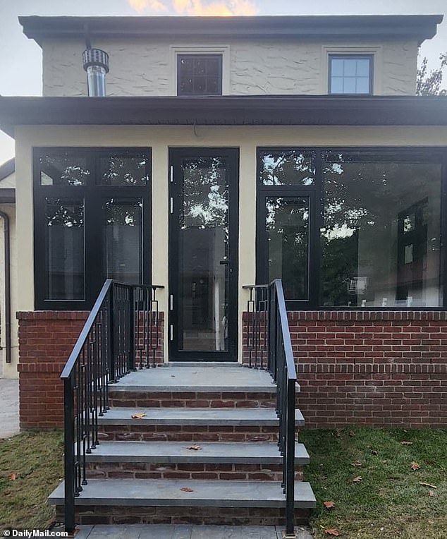 The back of the house has new windows, doors, stairs and banisters with a fresh paint job