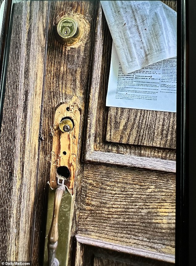 Neighbors claimed there was an attempted burglary at the property in August 2024. They said trespassers tried to break the door - a missing lock and keyhole on the door is shown here