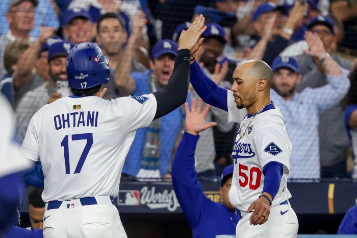 Shohei Ohtani gets a high-five from Mookie Betts