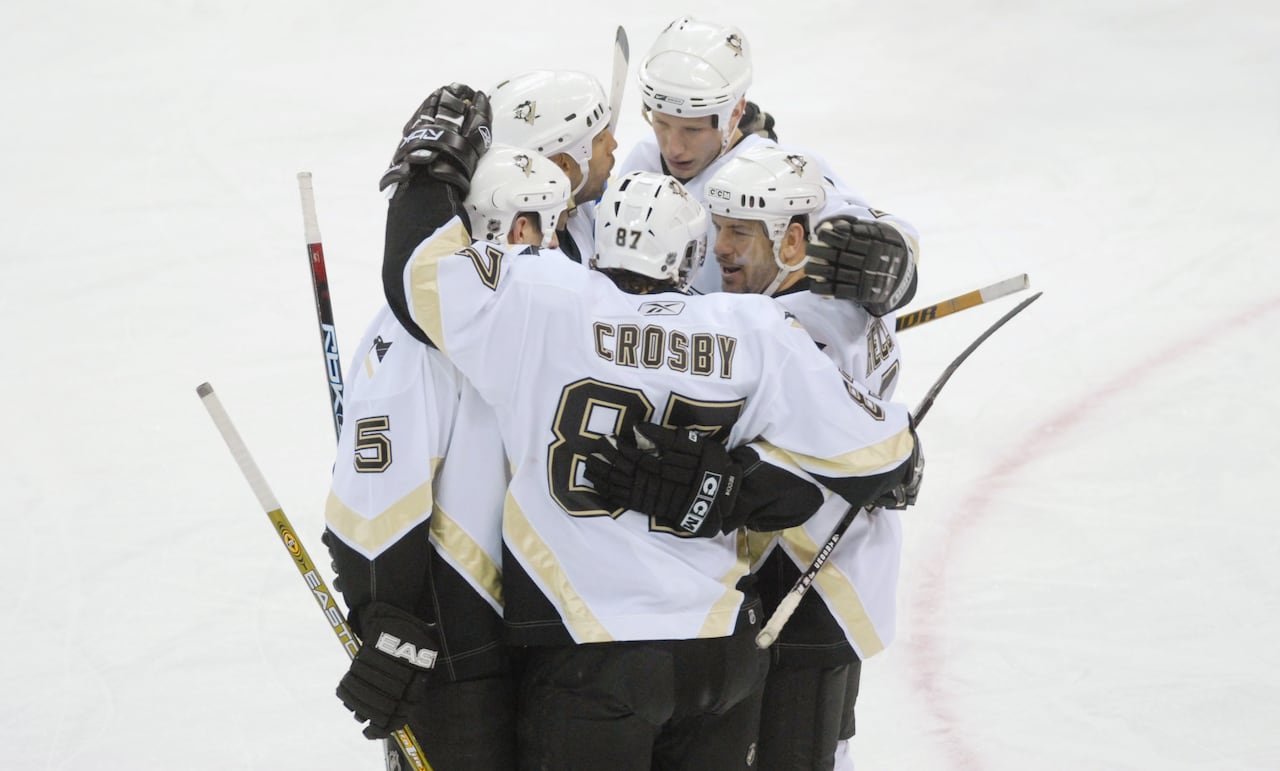 Sidney Crosby, 87, celebrates his 200th career point in a March 2, 2007, game, with teammates, including Alain Nasreddine, second from left.