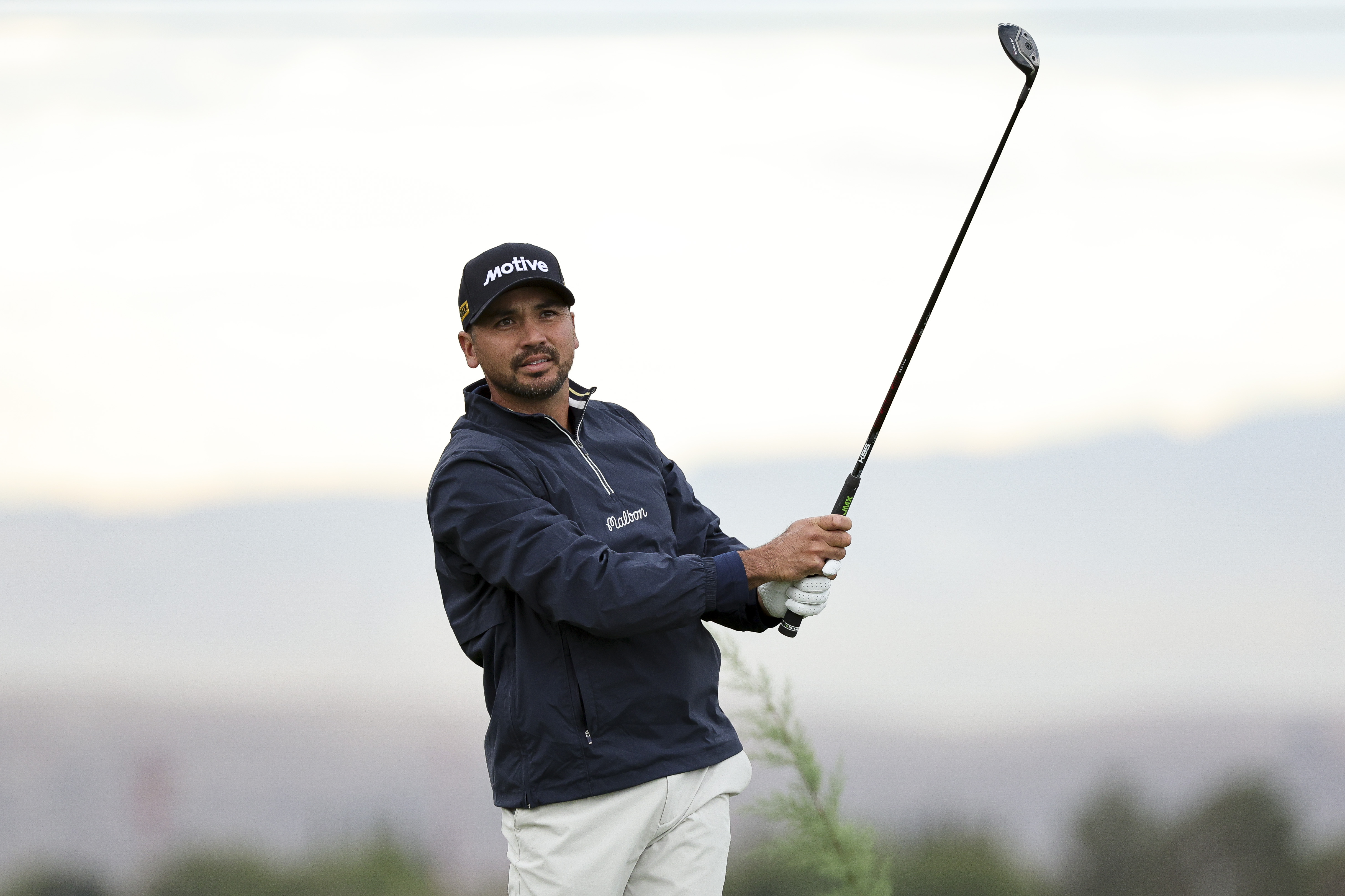 Jason Day hits a shot from the fairway and watches its flight