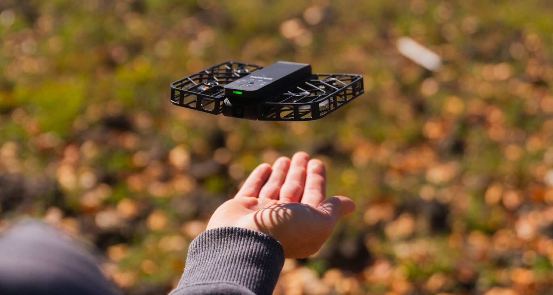 The HoverAir X1 hovering above a hand