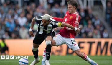 Joelinton of Newcastle United is challenged by Manuel Ugarte of Manchester United