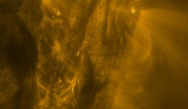 A close up of the sun showing golden light and energy spewing from its side