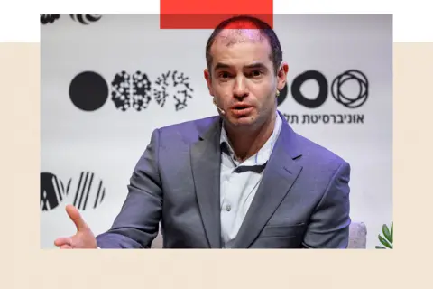 AFP via Getty Images Ilya Sutskever with a microphone
