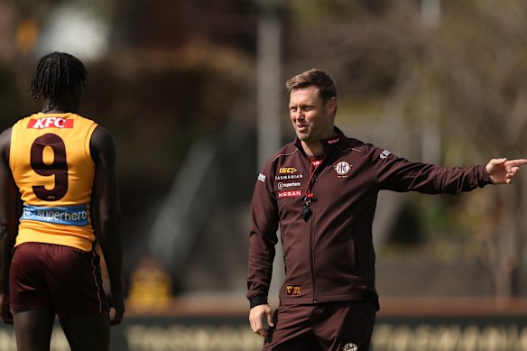 If a photo could talk: Changkuoth Jiath and Hawks coach Sam Mitchell.