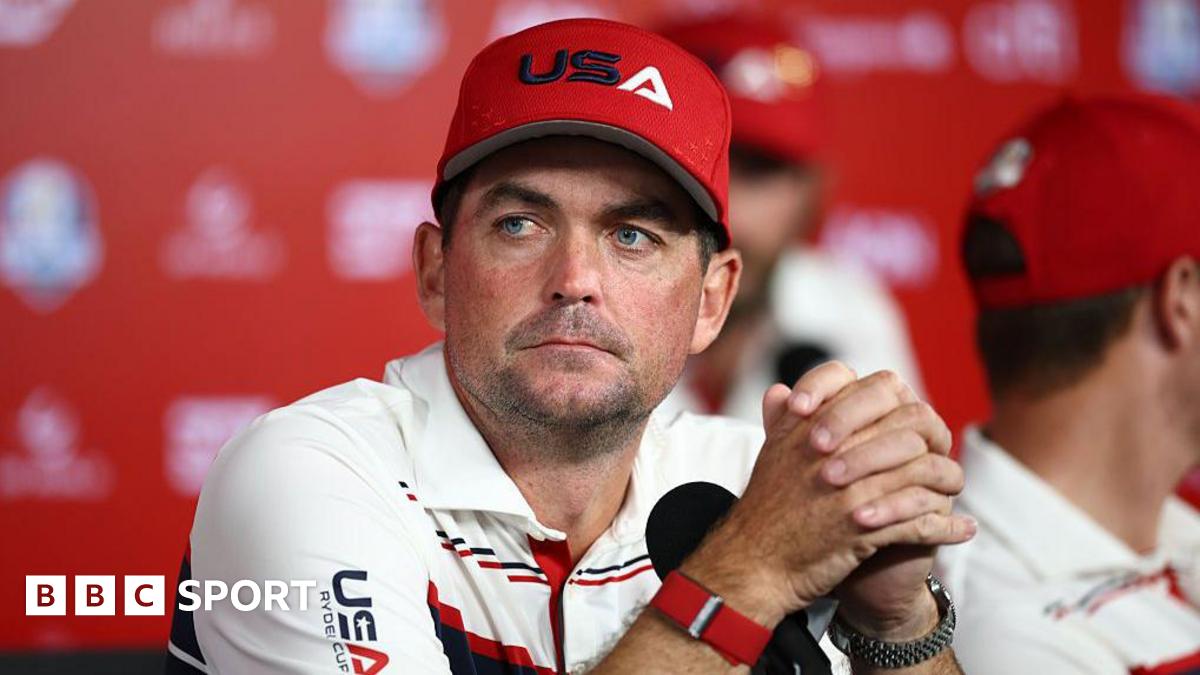 Keegan Bradley with his hands interlinked, staring into the distance
