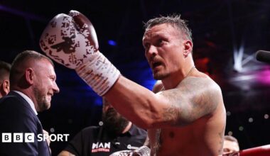 The FA Cup trophy, with red ribbons