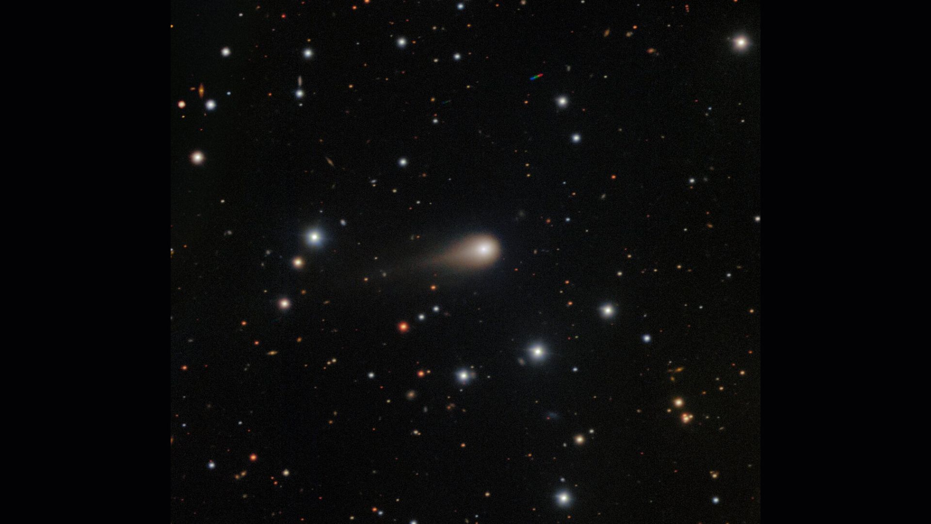 A streak of white shows interstellar comet 3I/ATLAS in the center of a starry night sky