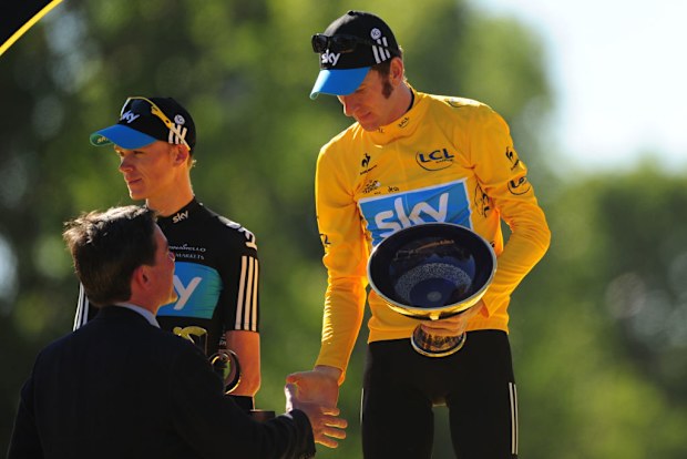 Sports Minister Hugh Robertson hands over the Trophy to Bradley Wiggins after he won the Tour De France 2012 Tour de France.