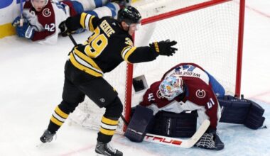 Boston Bruins forward Morgan Geekie reacts after stuffing the puck past Colorado Avalanche goalie Scott Wedgewood to score with five seconds remaining in the second period as Colorado defenseman Josh Manson watches in the background during a hockey game, Oct. 25, 2025, in Boston.