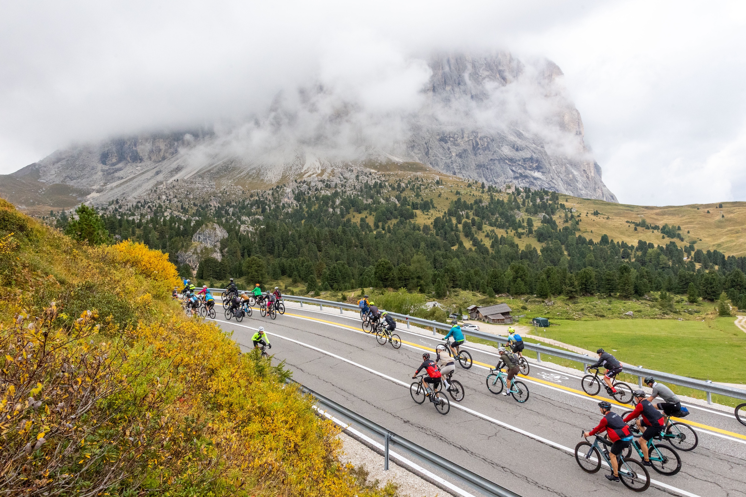 Riders in front of a cloud-wrapped mountain