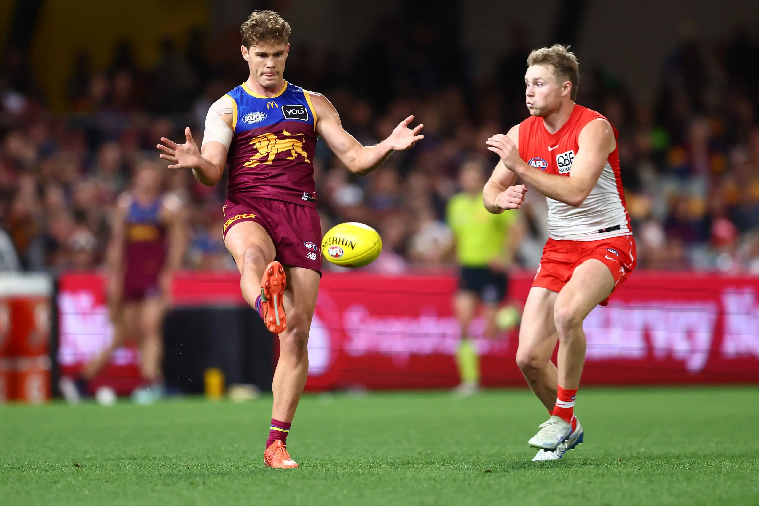 BRISBANE, AUSTRALIA - AUGUST 09: Deven Robertson of the Lions kicks during the round 22 AFL match between Brisbane Lions and Sydney Swans at The Gabba on August 09, 2025 in Brisbane, Australia. (Photo by Chris Hyde/AFL Photos/via Getty Images)