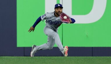 Los Angeles Dodgers outfielder Justin Dean fields the ball hit by Toronto Blue Jays' Alejandro Kirk during the ninth inning