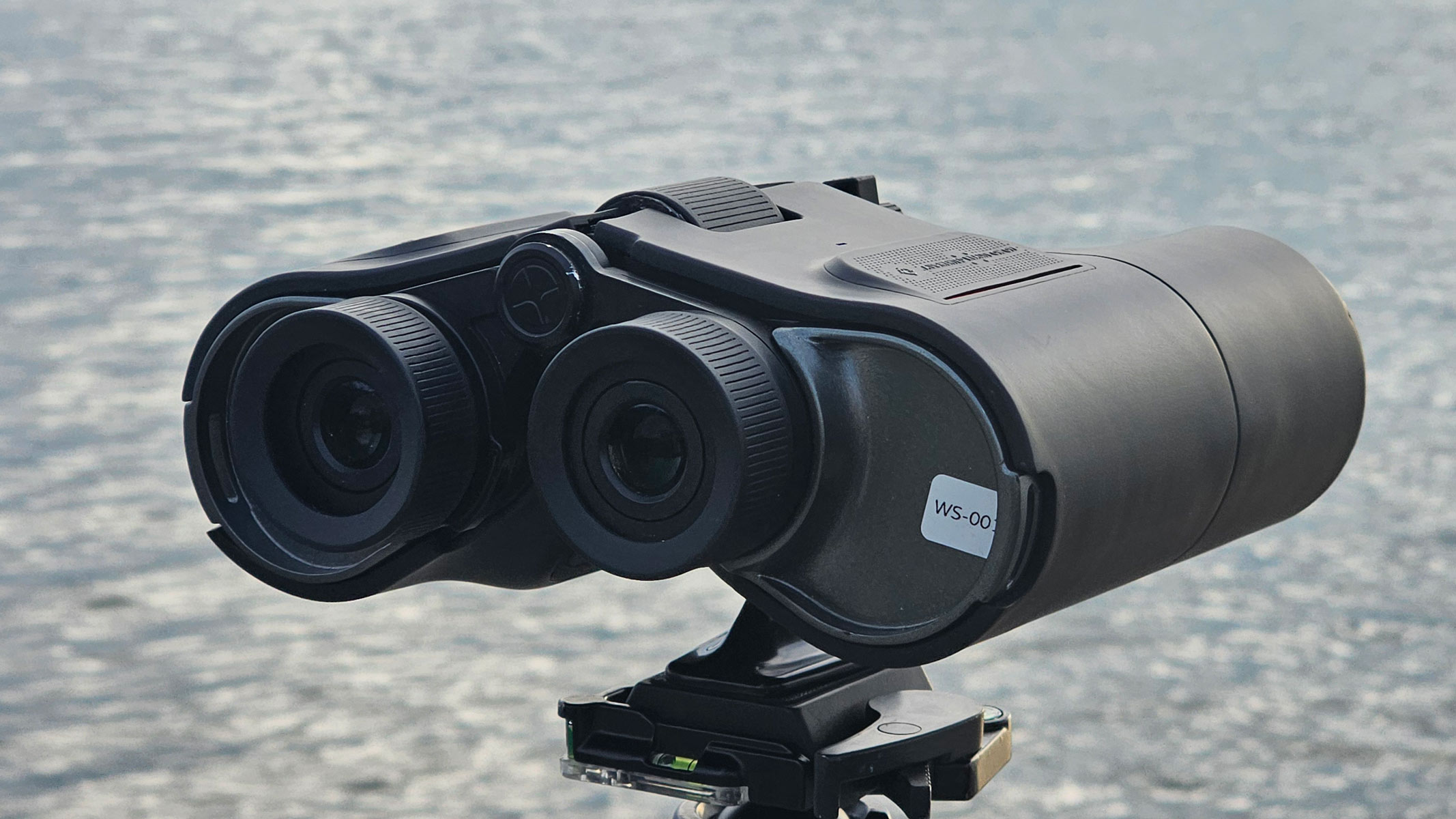 A back view of the Unistellar Envision smart binoculars with water in the background.
