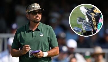 Jason Day writes in his yardage book, while looking at a golf bag