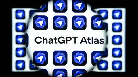 Getty Images A graphic of a magnifying glass over a screen, highlighting the words "ChatGPT Atlas". The logo, a white arrow in a blue circle, surrounds the text.