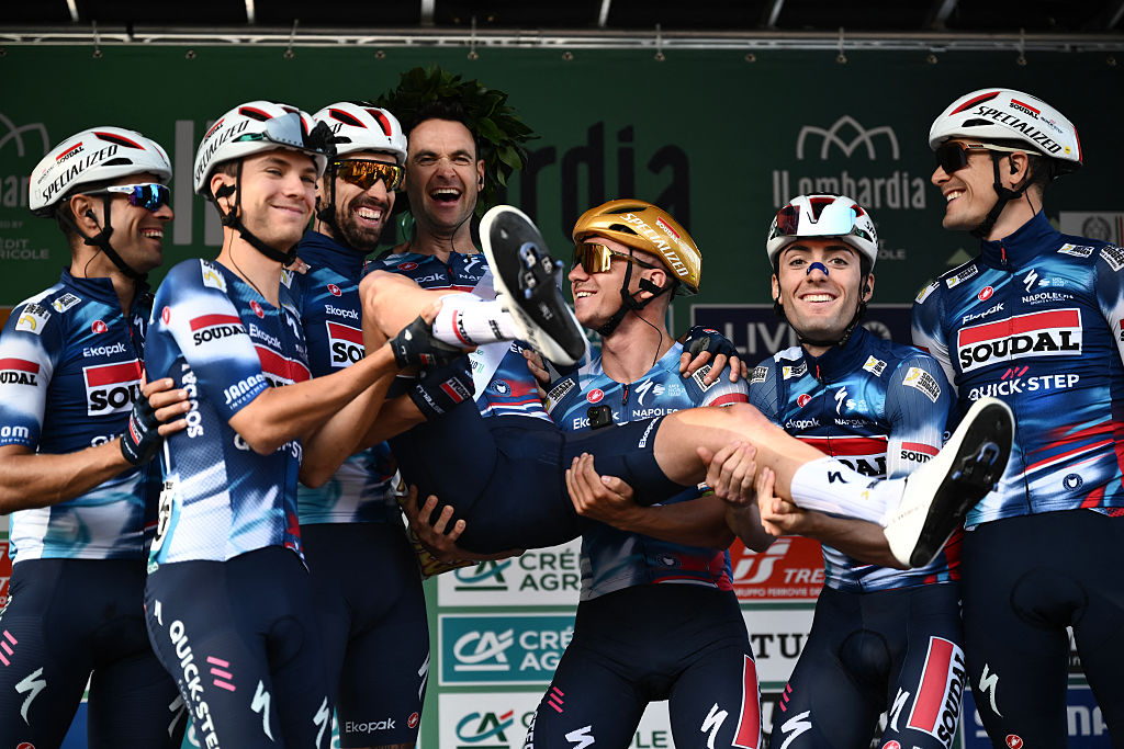 Soudal Quick-Step’s Belgian rider Pieter Serry (C) is hoisted up by teammates as he celebrates his last race, ahead of the 119th edition of the Giro di Lombardia (Tour of Lombardy), a 238km cycling race from Como to Bergamo on October 11, 2025. (Photo by Marco BERTORELLO / AFP)