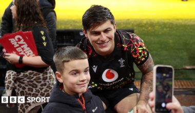 Louis Rees-Zammit poses with a fan at Wales' open training session at the Principality Stadium