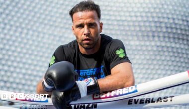 Felix Cash leans over the ropes as he poses for a photo