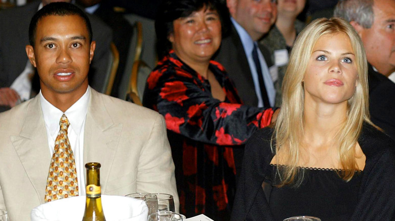 Tiger Woods wearing tan and Elin Nordegren wearing black in 2002