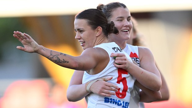 Chloe Molloy of the Swans celebrates kicking a goal.