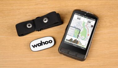 Wahoo Elemnt Ace with heart rate monitor on wooden backgorund