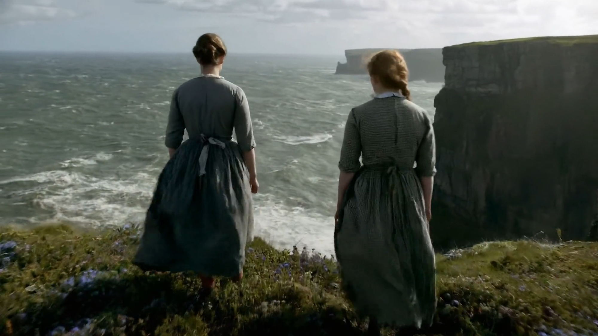 still from ai video showing two women standing on a cliffside
