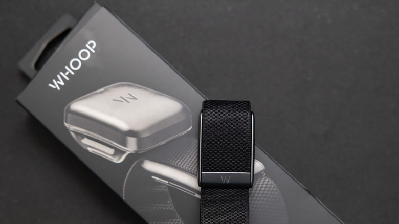 A Whoop band placed on its packaging