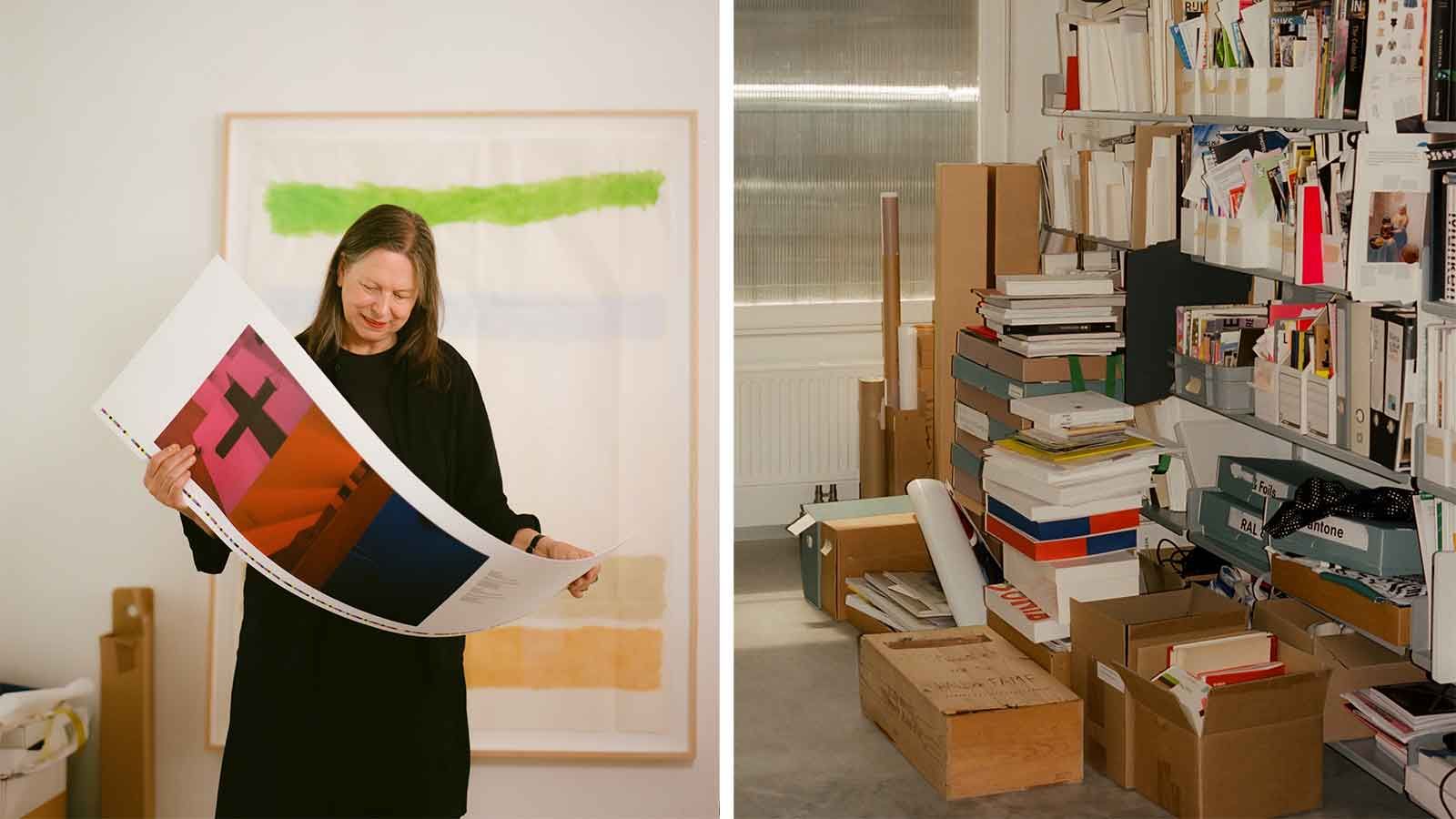 Irma Boom holding a poster in her studio