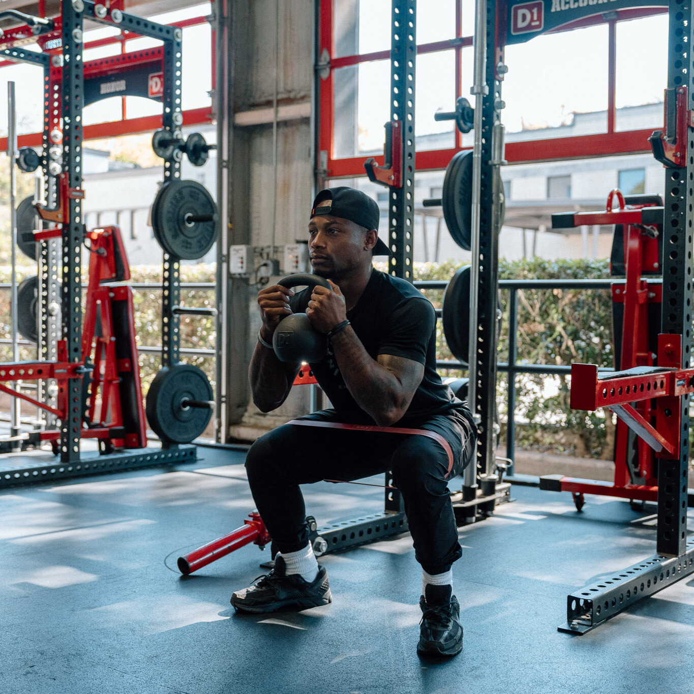 Man demonstrates kettlebell exercise in gym