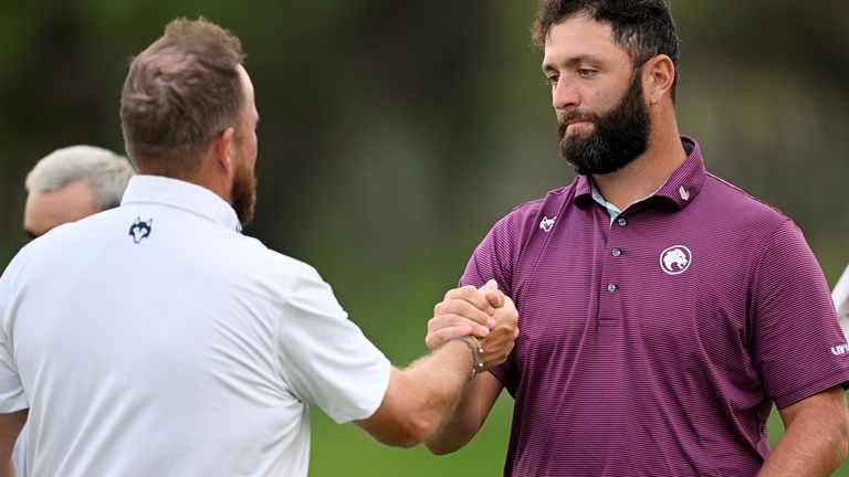 Shane Lowry and Jon Rahm shake hands after completing the second round in Madrid