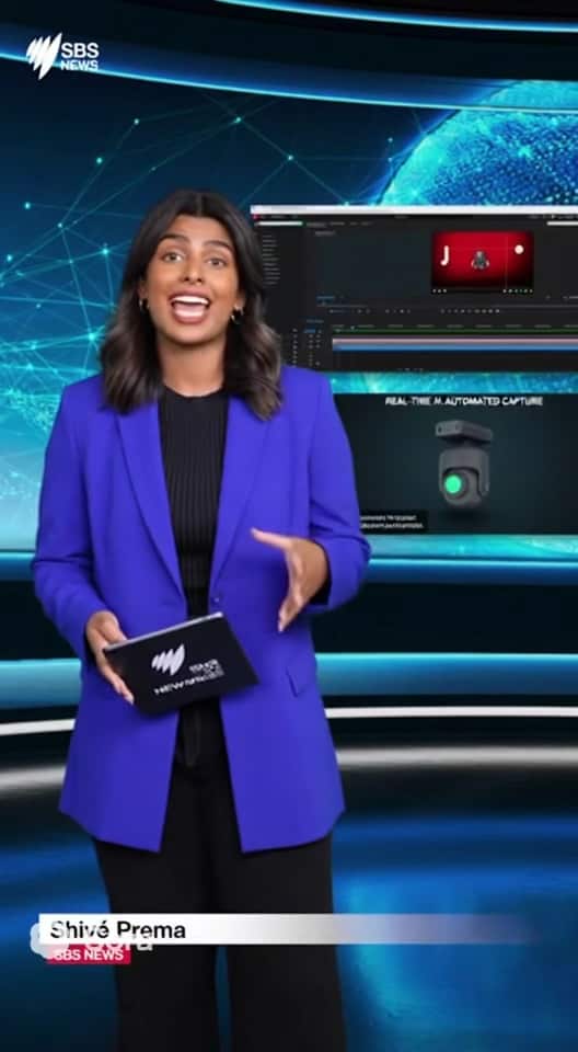 A woman in a blue blazer in a news studio