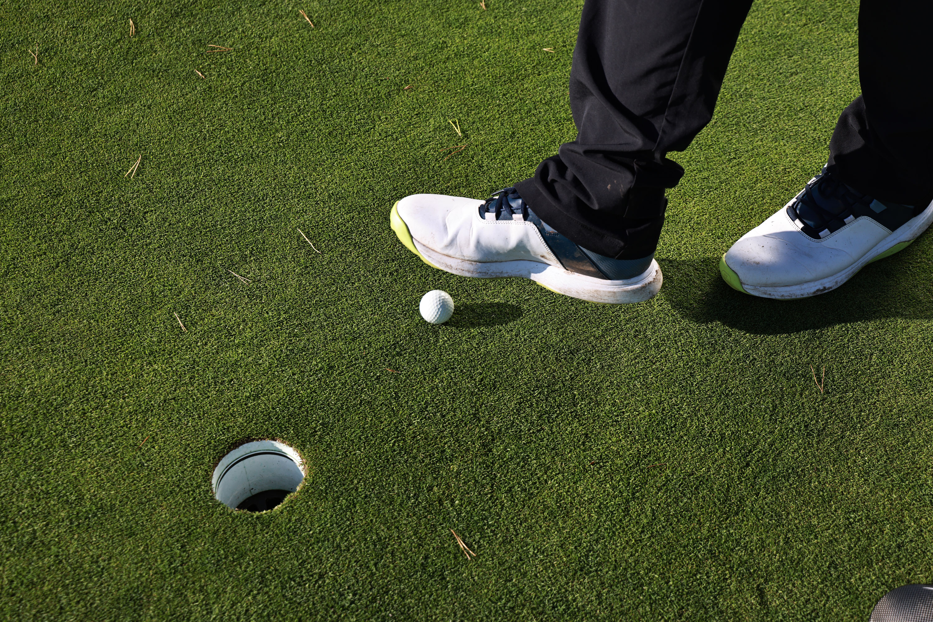 A player nudging the ball with their foot