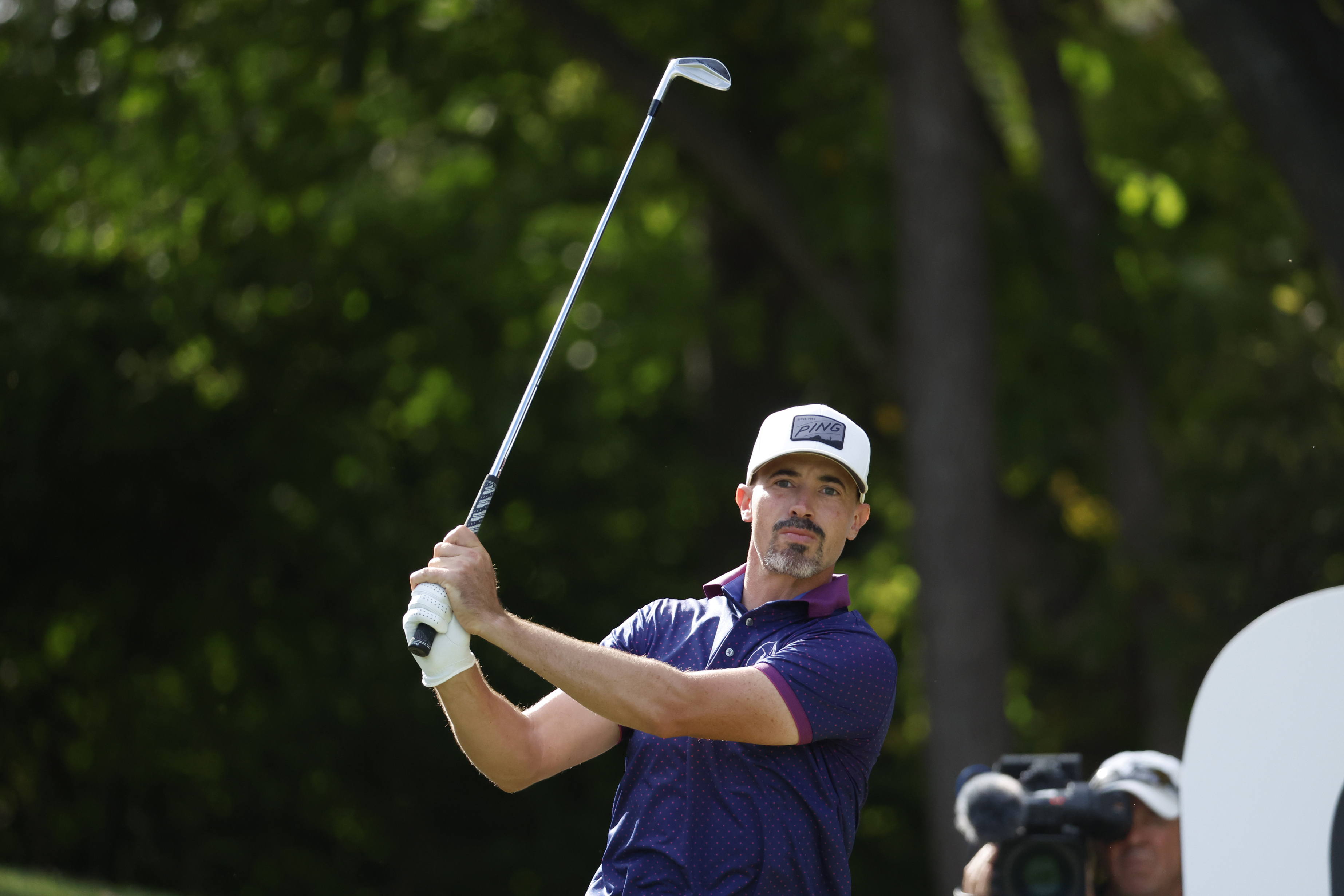 Paul Peterson hits an iron shot and watches its flight