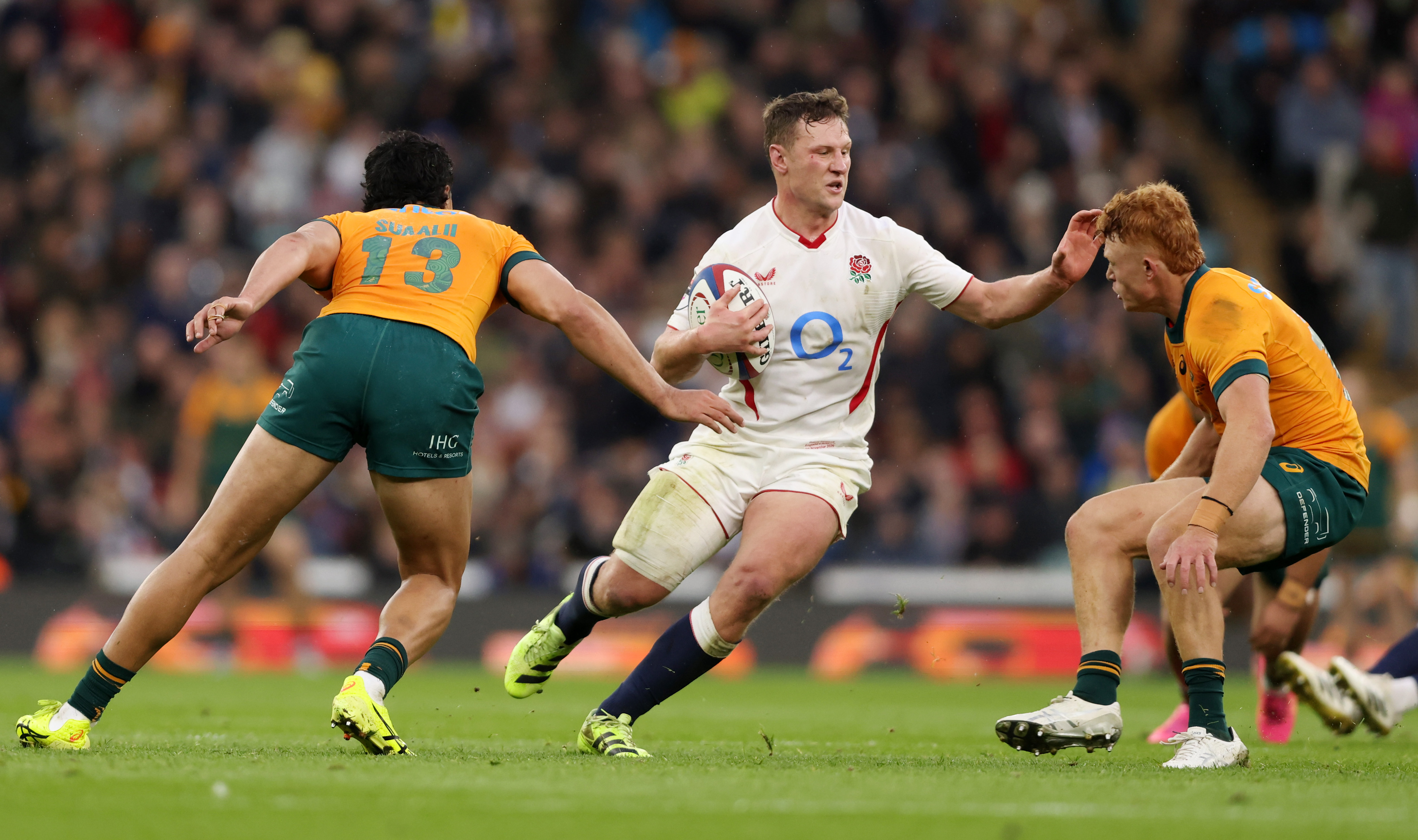 Fraser Dingwall of England carrying the ball against Joseph-Aukuso Suaalii and Tane Edmed of Australia during the Quilter Nations Series 2025.