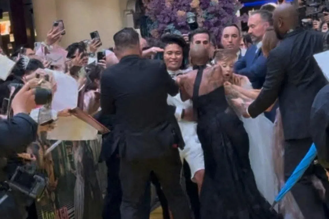 A man jumped a barricade and charged at Ariana Grande during Wicked: For Good's yellow carpet premiere at Universal Studios Singapore on Nov 13.