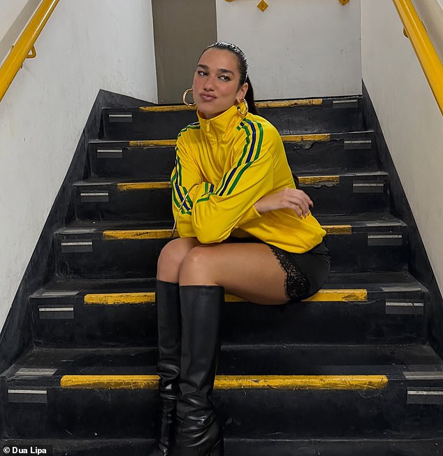Posing in a stairwell, she finished the look with a black mini skirt and knee-high boots to match