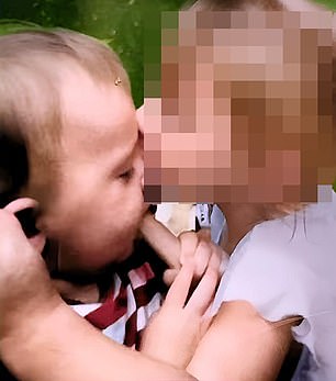 William's older sister, known legally as Lindsay  plants a kiss on her little brother