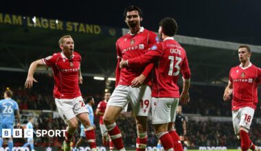 Wrexham striker Kieffer Moore celebrates with Lewis O'Brien and Liberato Cacace