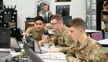 Cadets Daniel Bravo, Eric Shellabarger and Sean Mumm work in the MMA cyber classroom to fulfill the training requirements for their scholarship.