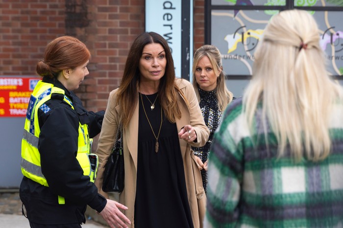 Carla is escorted away by a police woman and points at Lisa as a shocked Sarah watches on in Coronation Street