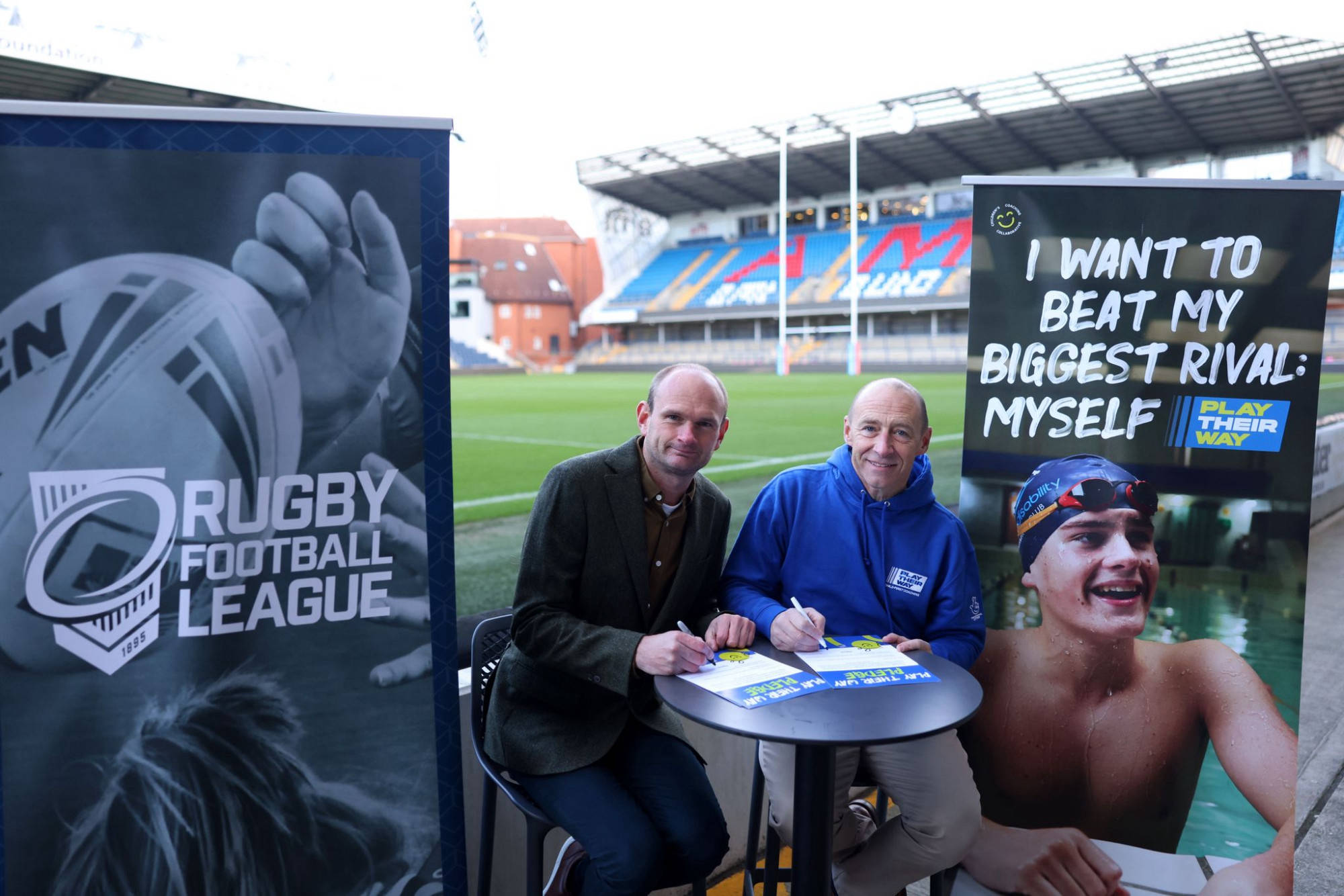 David Raybould from the RFL and Mark Gannon from UK Coaching sign the Play Their Pledge at Headingley on World Children's Day 