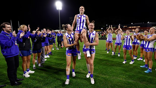 Jasmine Garner of the Kangaroos is chaired from the field after her 100th match.