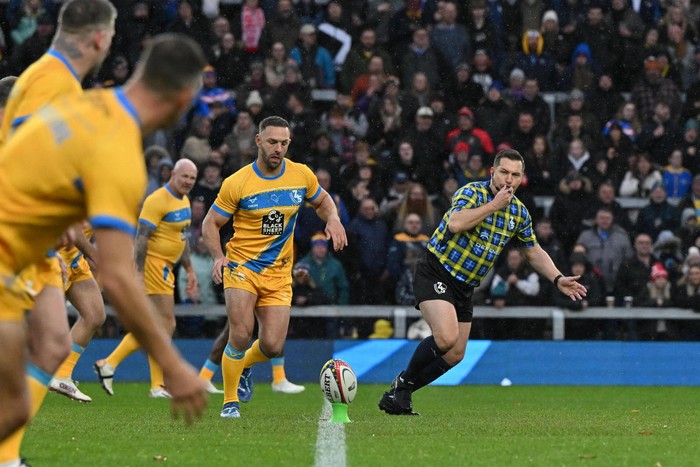 The referee blows his whistle as Team Burrow, in yellow and blue, kick off at The 745 Game.