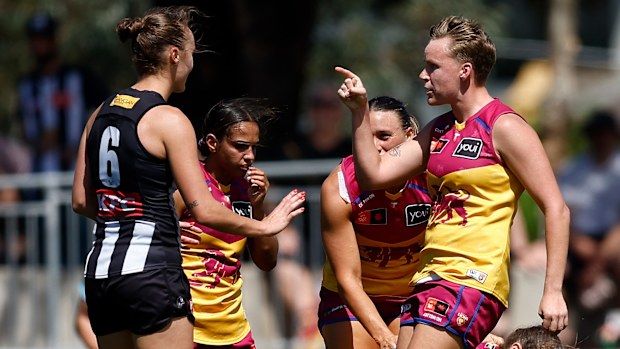 Jordyn Allen of the Magpies and Dakota Davidson of the Lions clash after the final siren.