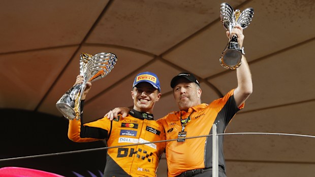 Lando Norris and Zak Brown on the podium with the trophies during F1 Grand Prix of Abu Dhabi.