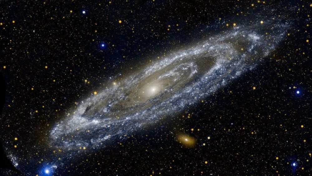 The resplendent Andromeda Galaxy (M31) as imaged by NASA's Galaxy Evolution Explorer. The yellowish galaxy below it is its satellite, M110, and the blue galaxy above it is M32. Andromeda has 39 known dwarf, satellite galaxies, and many of them are quenched long before they actually fall into Andromeda. Image Credit: NASA