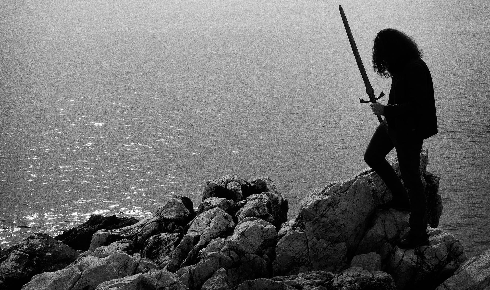 Erang overlooking the sea with a sword