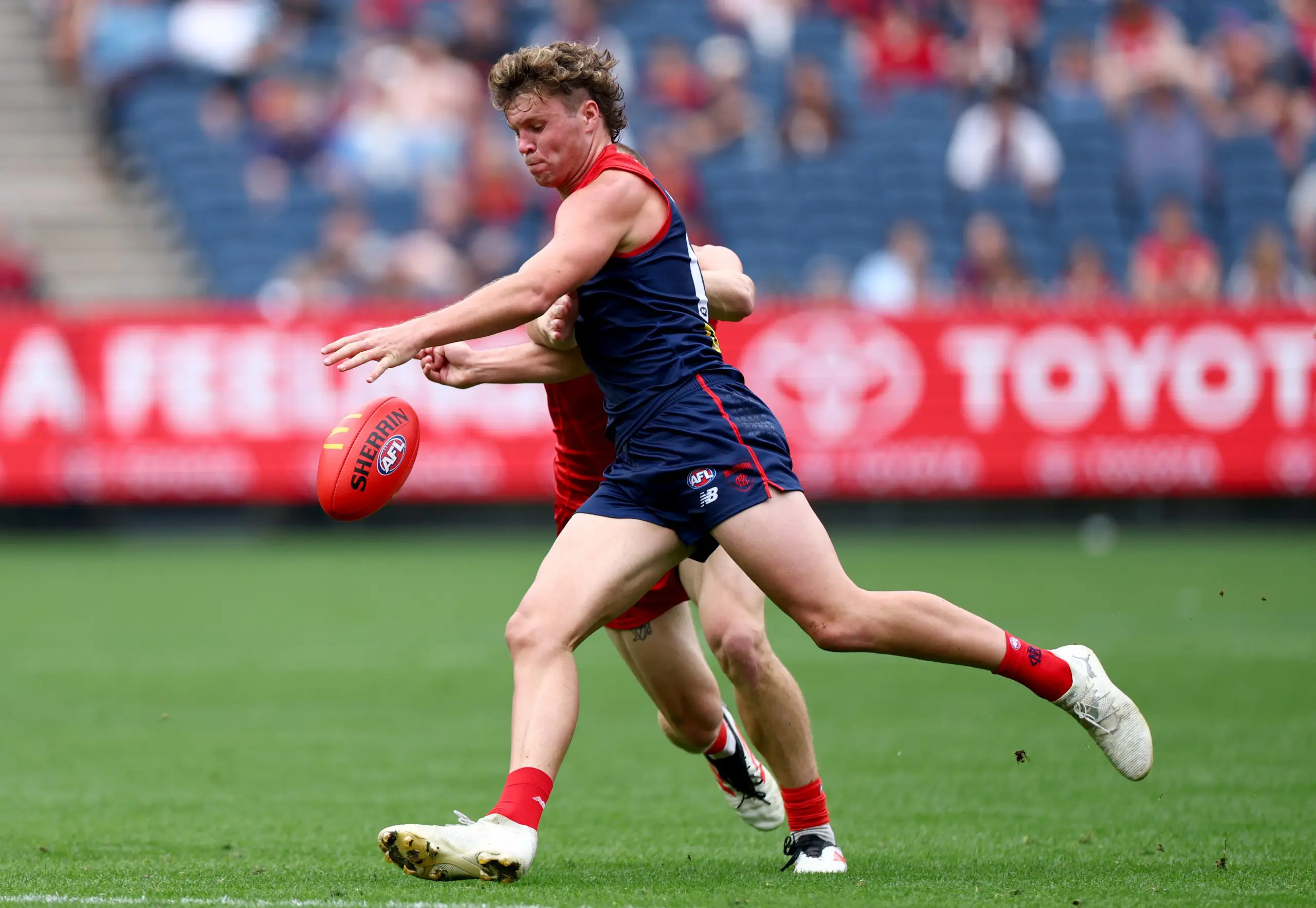MELBOURNE, AUSTRALIA - MARCH 29: Harvey Langford of the Demons kicks during the round three AFL match between Melbourne Demons and Gold Coast Suns at Melbourne Cricket Ground, on March 29, 2025, in Melbourne, Australia. (Photo by Josh Chadwick/AFL Photos/via Getty Images)